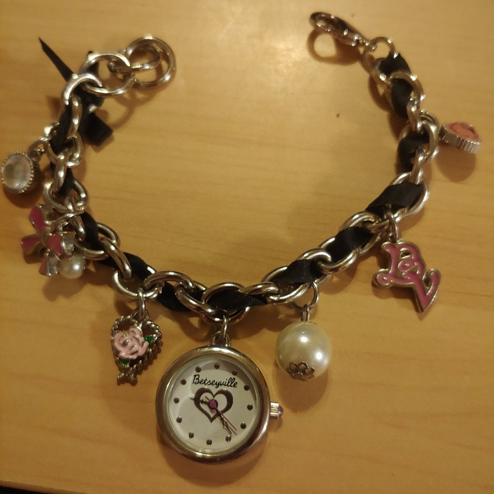 Betseyville wristwatch in charm bracelet style. Silver in tone and 6 charms.